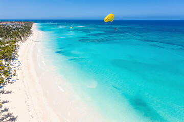 Wall Mural - Bounty and pristine sandy shore with coconut palm trees, caribbean sea washes tropical coast. Arenda Gorda beach. Dominican Republic. Aerial view