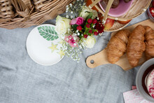 Picnic Basket And Plate Set Up With Flowers