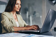 © undrey - Business woman working with laptop at her desk