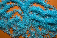 Blue Bath Salt Crystals On Orange. Background, Texture, Wallpaper.