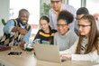 © tonefotografia - group of students studying and playing with teacher, education and learning concept.
