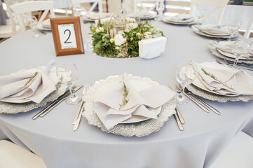 Wall Mural - A very beautiful festive table with candles, plates and glasses. Cool room decor