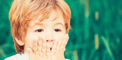 Shocked and surprised boy. Funny child boy. Smiling amazed or surprised child boy. Child expressing surprise with his hands in his face