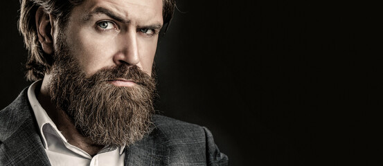 Portrait of handsome bearded man in suit. Male beard and mustache. Sexy male, brutal macho, hipster. Elegant handsome man in suit. Handsome bearded businessman