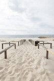 Fototapeta Kawa jest smaczna - Beautiful sandy beach by the ocean on a cloudy day