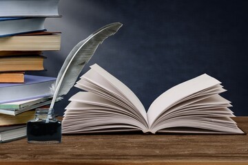 Wall Mural - old books and a fountain pen in an inkwell. concept on the theme of history, nostalgia, culture.