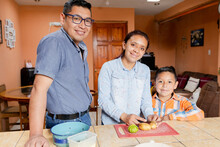 Small Latin Family Cooking Healthy Food At Home - Hispanic Housewife Preparing Food Together With Her Husband And Son