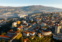 Picturesque Drone View Of Vila Real Cityscape In Valley Framed By Serra Do Alvao And Serras Do Marao Mountains In Light Fog On Sunny Spring Day, Portugal