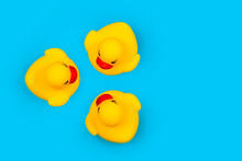 Rubber Toy Ducklings On A Blue Background.