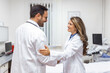 © Graphicroyalty - Two Professional confident doctor shaking hands while standing at the clinic .Teamwork of caucasian medical meeting and greeting by handshake at hospital .Medical team, health care concept.