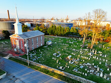 An Old Church With Graveyard In A Refinery Town
