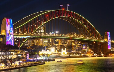 Wall Mural - Colourful Light show at night on Sydney Harbour NSW Australia. The bridge illuminated with lasers and neon coloured lights 