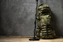 Metal Detector And Backpack On Dark Gray Background
