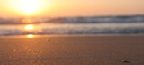 Fototapeta Kawa jest smaczna - Sea waves and warm sunset light, calm and relaxing sandy beach