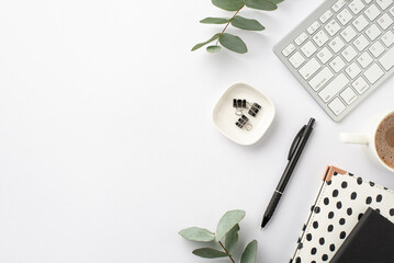 Business concept. Top view photo of workstation keyboard black and white stationery trendy note pads pen binder clips cup of hot drinking and green eucalyptus on isolated white background