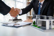© crizzystudio - Real estate agent and customers shaking hands together celebrating finished contract after about home insurance and investment loan, handshake and successful deal