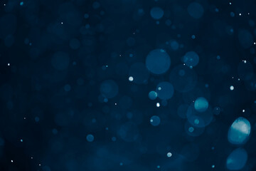 Deep blue bokeh glitter background. Christmas theme.