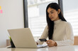 © ArLawKa - Attractive happy Asian woman online shopping with laptop, mobile, credit card and smartphone to shop with business idea concept background.