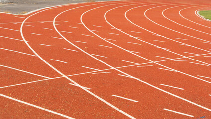 Rubber floor, red running track on a sports stadium with grandstand. Sport and recreation background.