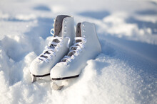 Close Up White Leather Figure Skates And Copy Space Lie On The Snow