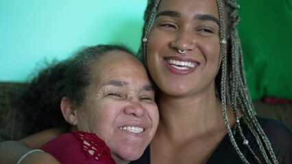 portrait of happy mother and daughter smiling and hugging. two hispanic latin south american people