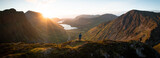 Fototapeta Fototapety góry  - Hiker at top of mountain, Sunset Panorama