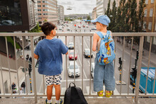 Children Standing On Viaduct And Looking At Traffic