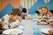 © Johnér - Children having lunch in cafeteria