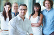 © Marine Gastineau/peopleimages.com - The team that wins. Cropped shot of a businessman sitting in front of his colleagues in the office.