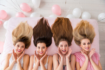 Wall Mural - Above view photo of four charming cheerful girl laying linen sheets bed prepare hairdo house indoors