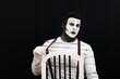 © Nitroframe - retro mime performing show with suspenders in a black background