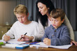 © Alex F/peopleimages.com - Education starts at home. Shot of a mother helping her sons with their homework.