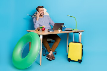 Wall Mural - Full size photo of happy emotion blonde travel agency man talk with potential client isolated on blue color background