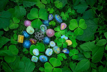 Rune Stones With Symbols And Clover Leaves On Abstract Dark Natural Background. Minerals Pebble With Rune Signs For Fortune Telling, Prediction Destiny. Ancient Witch And Shaman Magic Ritual. Top View