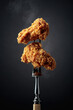 canvas print picture - Fried chicken on a fork.