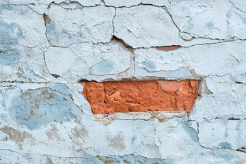 Wall Mural - Ancient weathered brick wall with cracks and destroyed stucco layer. old brick wall. Vintage background texture. Cracked concrete vintage wall background, old brick wall