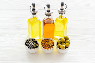 Wall Mural - Different kind of cooking oil - sunflower olive and sesame oil with seeds