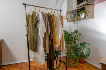 Wall Mural - Second-hand clothes  on the rail at home. The concept of sustainable economic life