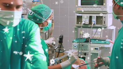 Wall Mural - Animation of stars floating over diverse surgeons during operation