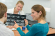 © auremar - young female reviewing brain xrays with husband