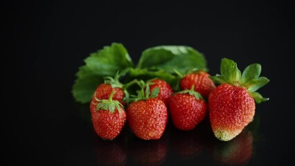 Wall Mural - Ripe juicy red strawberry isolated on black background