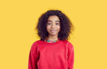happy child in casual clothes. positive little kid isolated on solid bright yellow color background.
