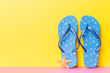 Beach Accessories. Flip Flops And Starfish On Colored Background. Mock Up With Copy Space