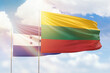 Sunny blue sky and flags of lithuania and honduras