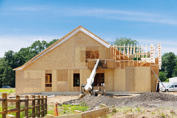 Wall Mural - A residential house construction project showing the plywood roof and oriented strand board wall sheathing