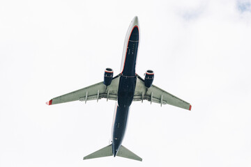 Passenger plane comes in for landing in cloudy weather.