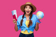 © khmelev - Shocked happy woman with passport and ticket holding globe on isolated background. Concept of tourism