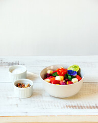 Wall Mural - fruit salad on light wooden background