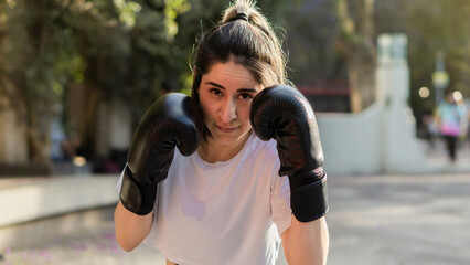 Wall Mural - Portrait of a beautiful Caucasian woman finishing her boxing classes.