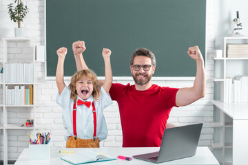 Fototapete - Excited school kid and teacher learning study in class. Education and knowledge.